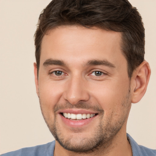 Joyful white young-adult male with short  brown hair and brown eyes