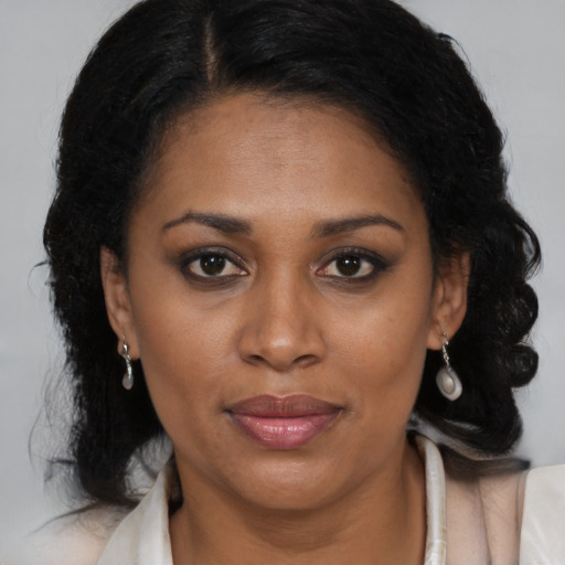 Joyful black adult female with medium  black hair and brown eyes
