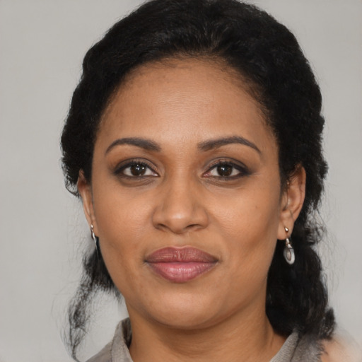 Joyful black adult female with medium  black hair and brown eyes