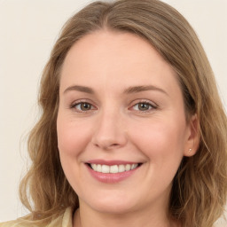 Joyful white young-adult female with medium  brown hair and green eyes