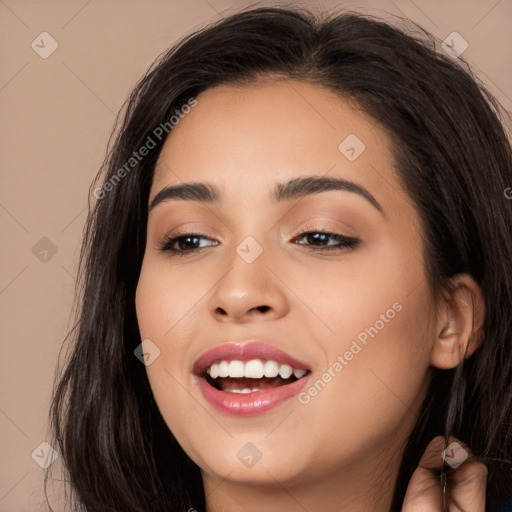 Joyful white young-adult female with long  black hair and brown eyes