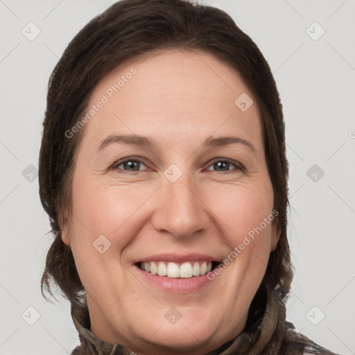 Joyful white adult female with long  brown hair and brown eyes