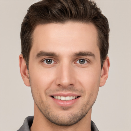 Joyful white young-adult male with short  brown hair and brown eyes