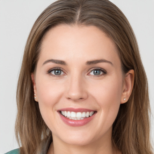 Joyful white young-adult female with long  brown hair and grey eyes