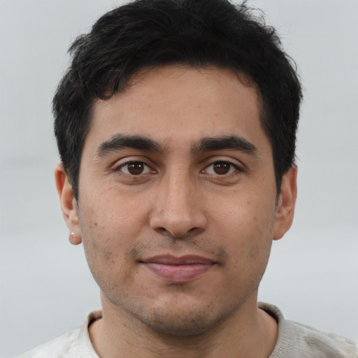 Joyful asian young-adult male with short  black hair and brown eyes