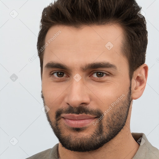 Joyful white young-adult male with short  brown hair and brown eyes