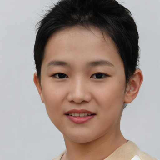 Joyful asian child female with short  brown hair and brown eyes