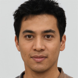 Joyful asian young-adult male with short  black hair and brown eyes