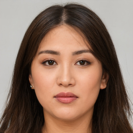 Neutral white young-adult female with long  brown hair and brown eyes