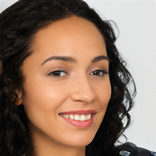 Joyful latino young-adult female with long  brown hair and brown eyes