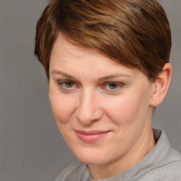 Joyful white adult female with short  brown hair and grey eyes