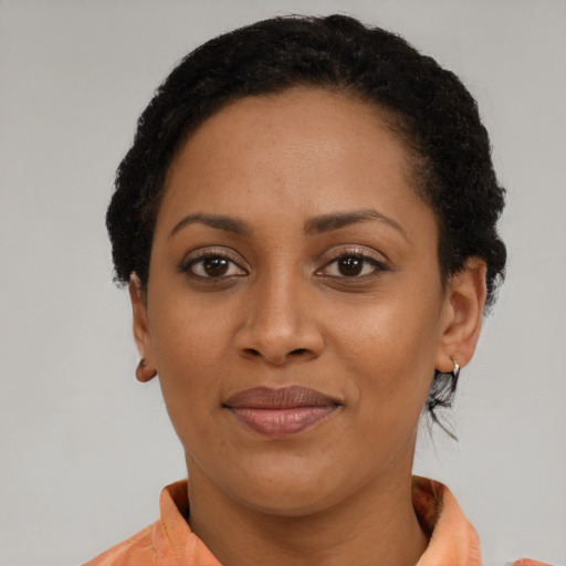 Joyful black adult female with short  brown hair and brown eyes