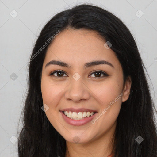 Joyful latino young-adult female with long  brown hair and brown eyes