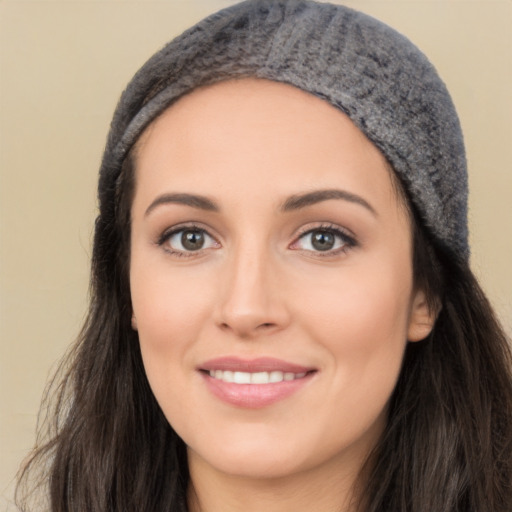 Joyful white young-adult female with long  black hair and brown eyes