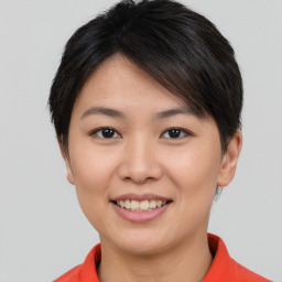 Joyful asian young-adult female with short  brown hair and brown eyes