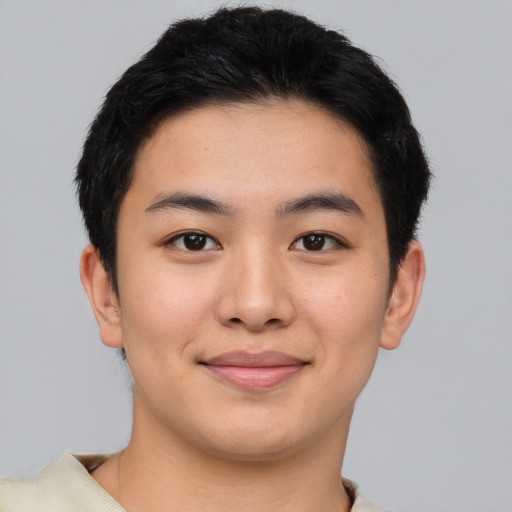 Joyful asian young-adult male with short  brown hair and brown eyes