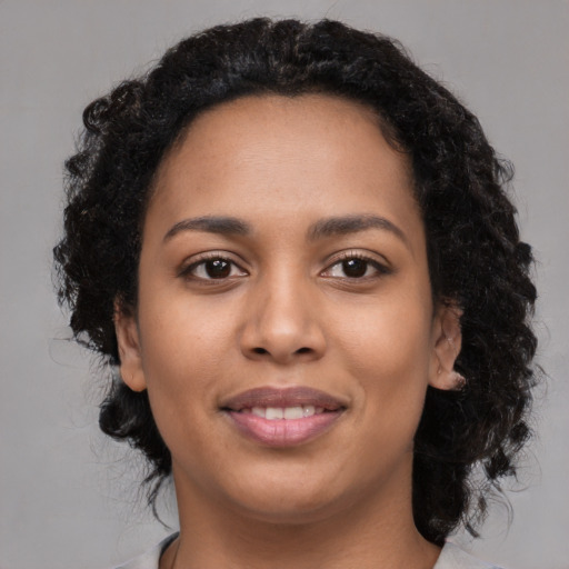 Joyful latino young-adult female with medium  black hair and brown eyes