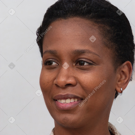 Joyful black young-adult female with short  brown hair and brown eyes