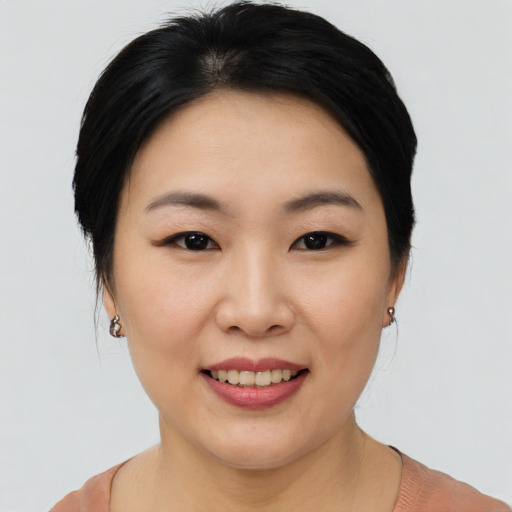 Joyful asian young-adult female with short  black hair and brown eyes