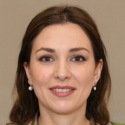 Joyful white young-adult female with medium  brown hair and grey eyes