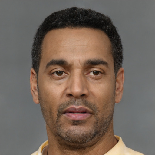 Neutral latino adult male with short  brown hair and brown eyes