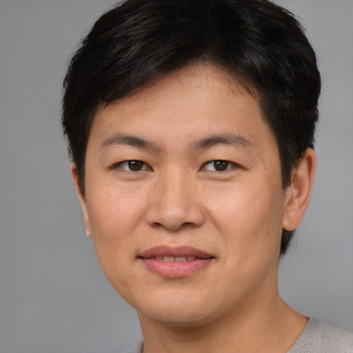 Joyful asian young-adult female with short  brown hair and brown eyes