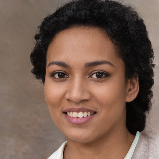 Joyful latino young-adult female with short  brown hair and brown eyes