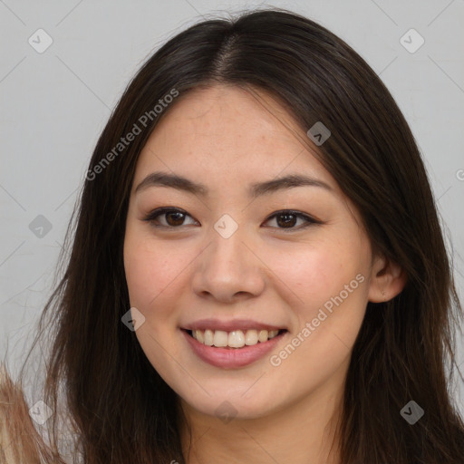 Joyful asian young-adult female with long  brown hair and brown eyes