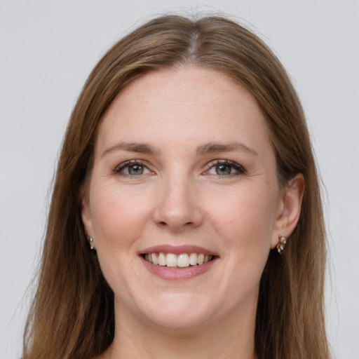 Joyful white young-adult female with long  brown hair and grey eyes