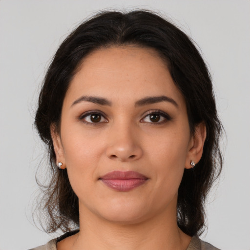 Joyful latino young-adult female with medium  brown hair and brown eyes