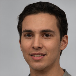 Joyful white young-adult male with short  black hair and brown eyes