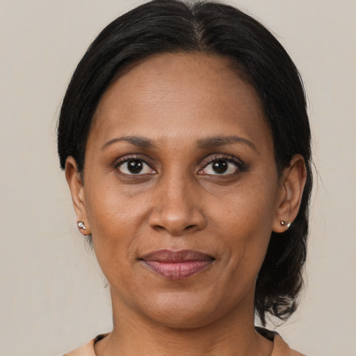 Joyful latino adult female with medium  brown hair and brown eyes
