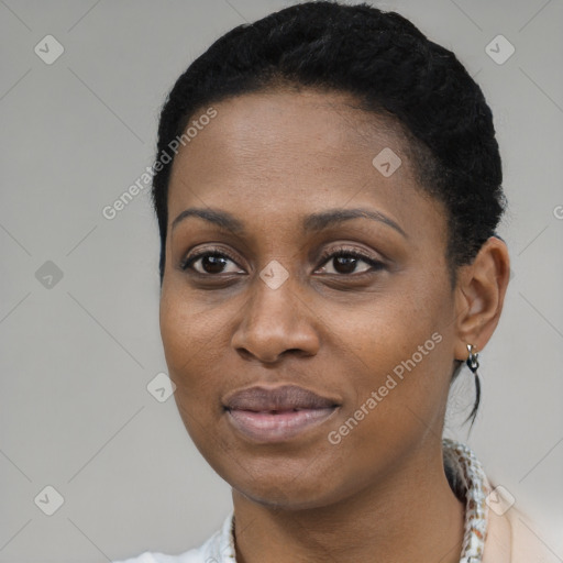 Joyful black young-adult female with short  black hair and brown eyes