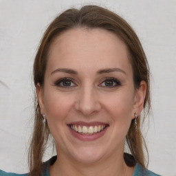 Joyful white young-adult female with medium  brown hair and grey eyes