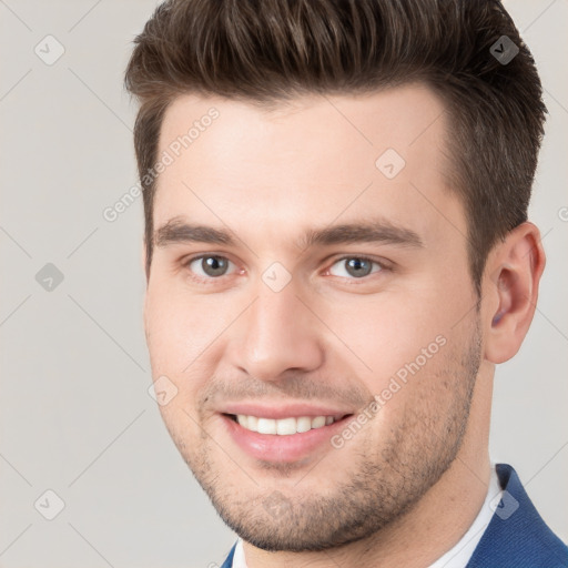 Joyful white young-adult male with short  brown hair and brown eyes