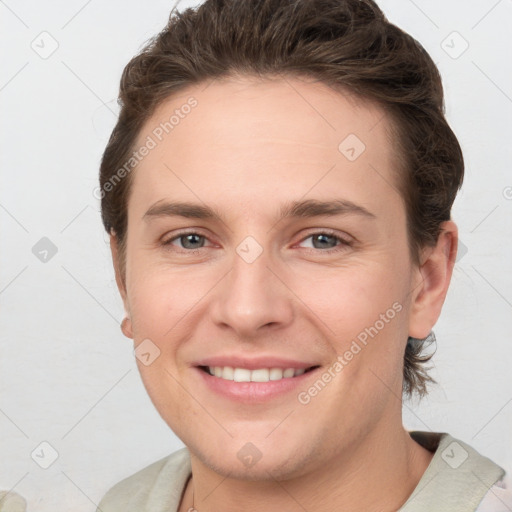 Joyful white young-adult female with short  brown hair and grey eyes