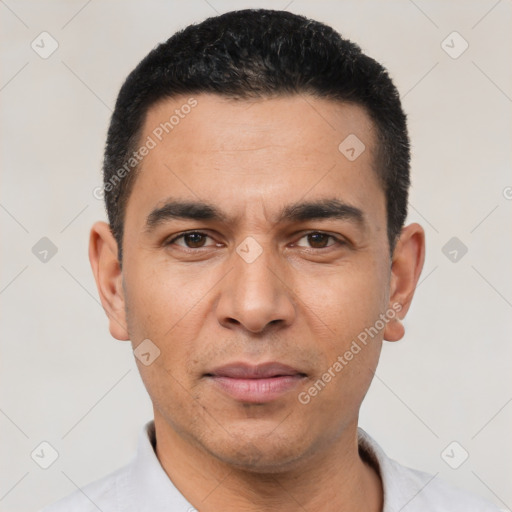 Joyful white young-adult male with short  black hair and brown eyes