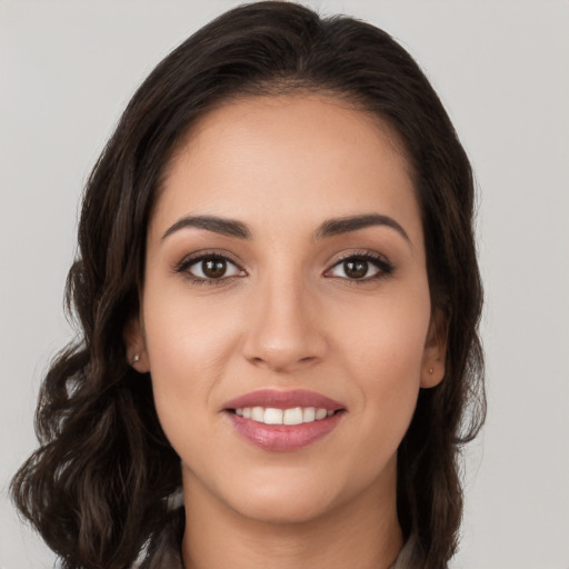 Joyful white young-adult female with long  brown hair and brown eyes