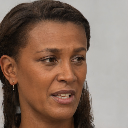 Joyful latino adult female with short  brown hair and brown eyes