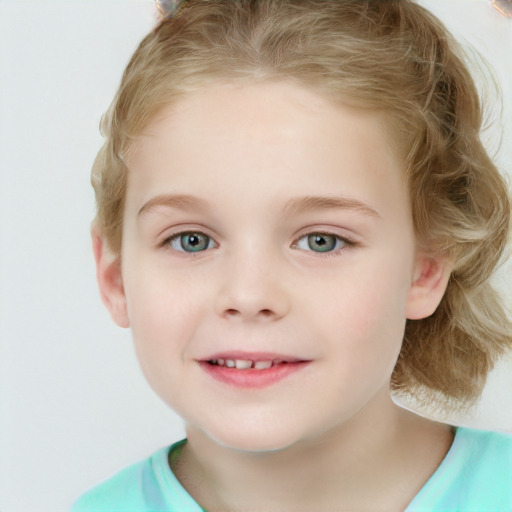 Joyful white child female with short  brown hair and blue eyes