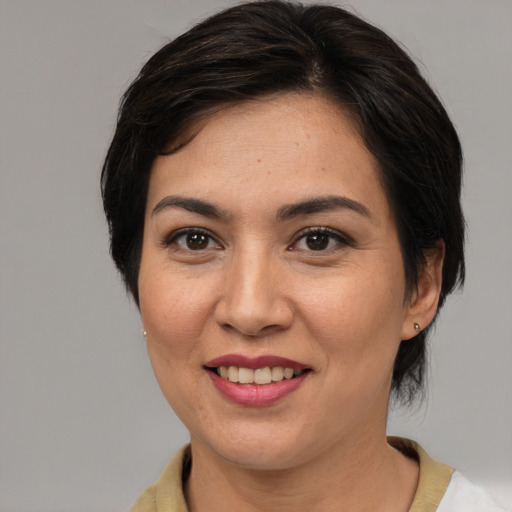 Joyful asian adult female with medium  brown hair and brown eyes