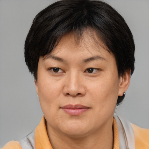 Joyful asian adult female with short  brown hair and brown eyes