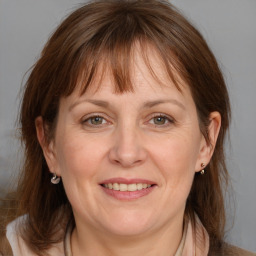 Joyful white adult female with medium  brown hair and brown eyes