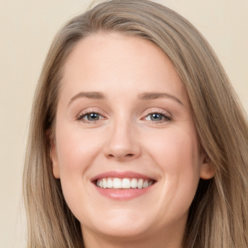 Joyful white young-adult female with long  brown hair and grey eyes