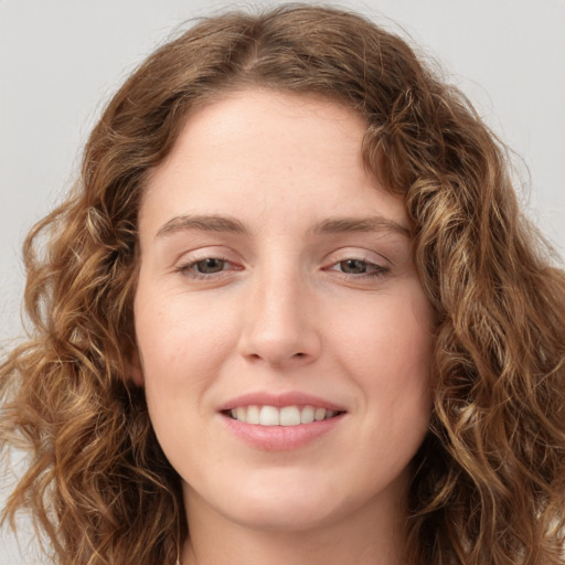 Joyful white young-adult female with long  brown hair and green eyes