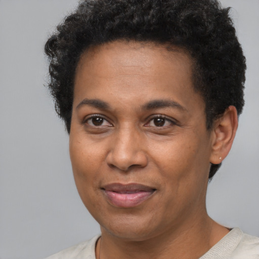 Joyful black young-adult female with short  brown hair and brown eyes