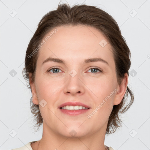 Joyful white adult female with medium  brown hair and grey eyes