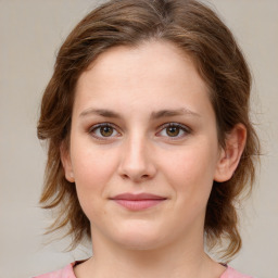 Joyful white young-adult female with medium  brown hair and green eyes