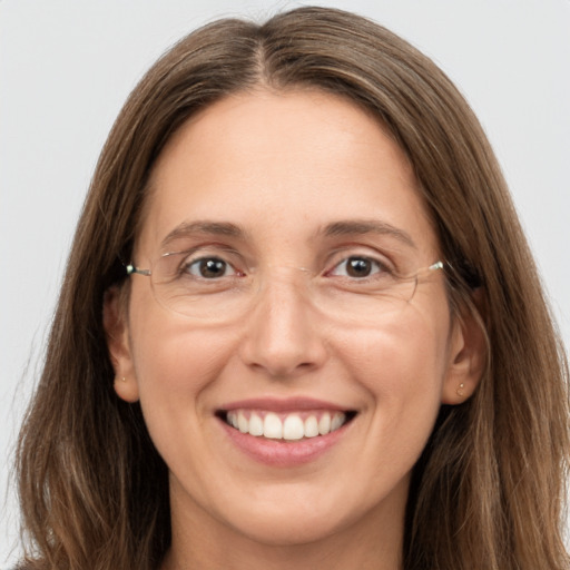 Joyful white young-adult female with long  brown hair and grey eyes