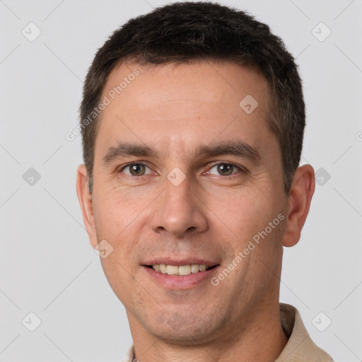 Joyful white adult male with short  brown hair and brown eyes